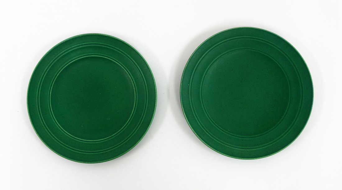 Keith Murray for Wedgwood: Two matt green glazed plates, with concentric banding, factory marks to the base of each. D. 210mm