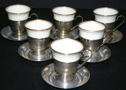 Six (6) demitasse sterling coffee holders with ste: Six (6) demitasse sterling coffee holders with sterling under tray and Lennox cups. Cups marked sterling "W" 9211. 26.7 grams.