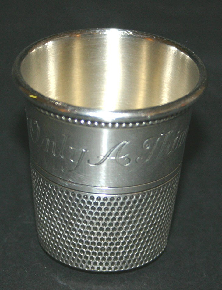 Sterling thimble shot glass. Reads "Only a thimbl: Sterling thimble shot glass. Reads "Only a thimble full." Marked sterling and monogramed. 2". 4.3 grams.