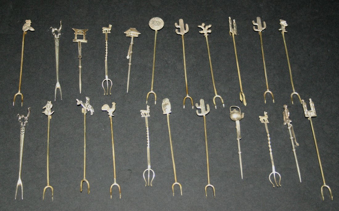 Twenty-two (22) sterling hors d'oeuvre forks with : Twenty-two (22) sterling hors d'oeuvre forks with tops including animals, cactus, tea kettle, figurines, etc.. Marked 9.25. 3 1/2"L. 6 grams.