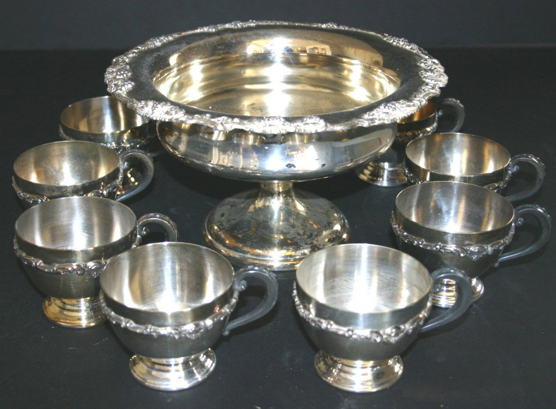 Sheffield silverplate punch bowl set with eight (8: Sheffield silverplate punch bowl set with eight (8) cups. Bowl has leaf & grape pattern and measures 9 1/2"D x 5 1/2"H. Cups have decoration & Quadra plate handles.