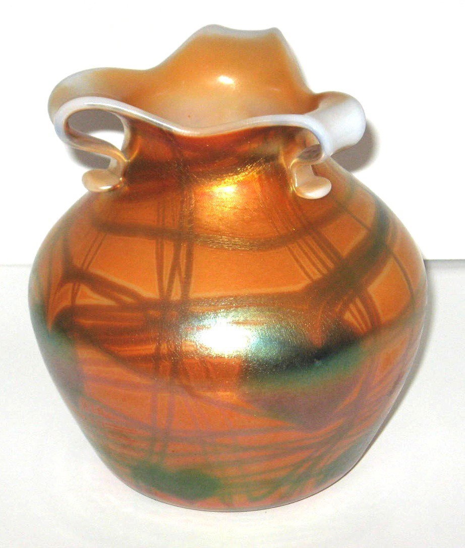 Imperial Free Hand three handle vase,: ovoid form in iridescent orange decorated with blue hearts and vines and carries original Imperial paper label, 7" ht. LITERATURE: see Imperial Glass Encyclopedia Volume II Nation Imperial Glass Colle