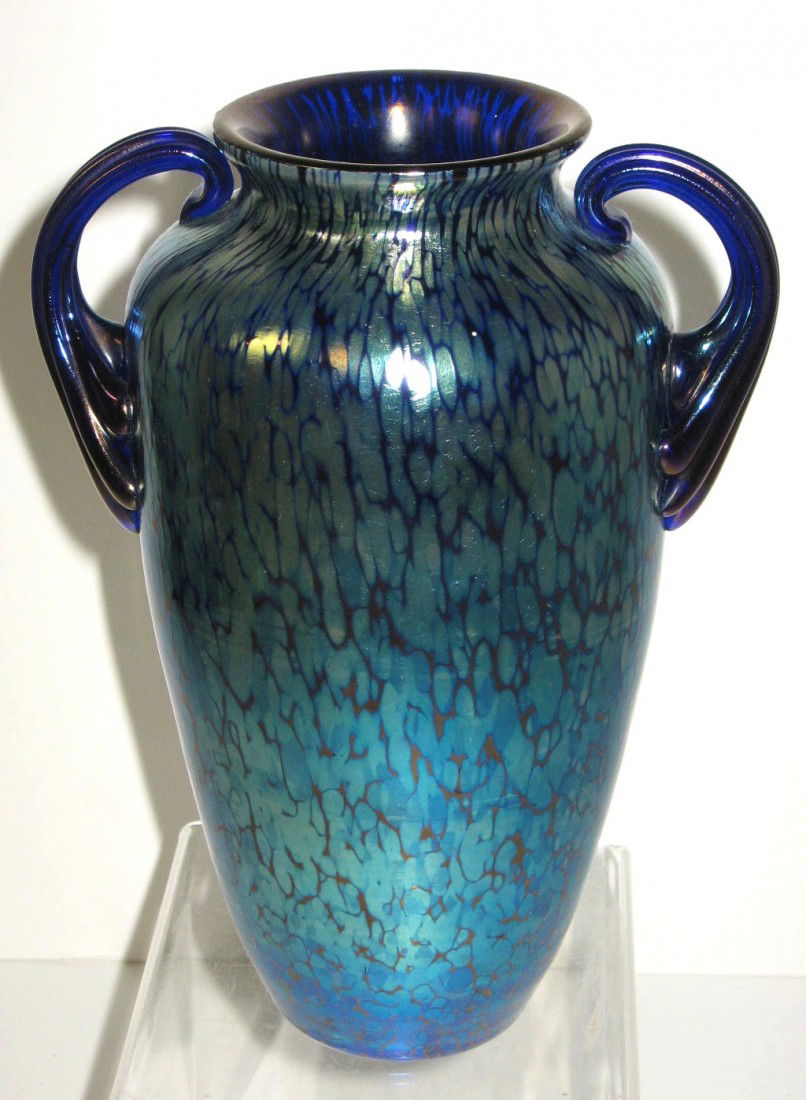 Loetz Two handled blue vase,: cylindrical urn form in iridescent cobalt decorated with a rich oil spot finish, adorned with two side reeded handles, signed Czecho Slovakia, 7 1/4" ht.