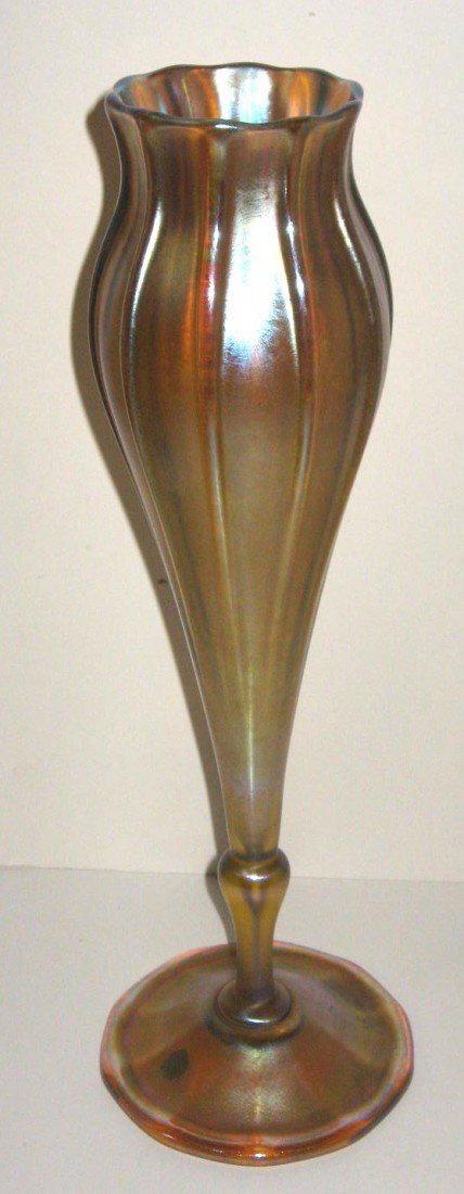 Large Tiffany gold Favrile flower form 1911: trumpet form with exaggerated ribs and a subtle scalloped rim, signed 1527-8820M L. C. Tiffany Inc Favrile, and carries a partial Marshall Field retail label, 15" ht. No Chips or Cracks