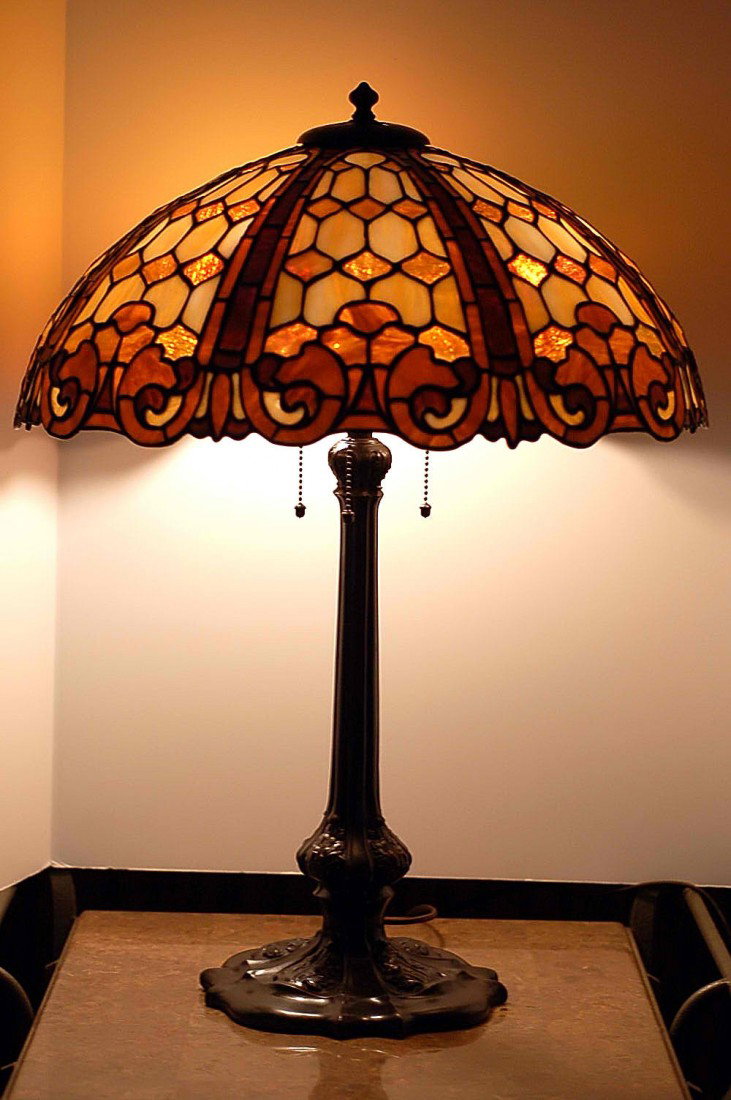 Opulent Duffner and Kimberly "Colonial" leaded gla: Opulent Duffner and Kimberly "Colonial" leaded glass table lamp, circa 1908. Stands 24" tall. The intricately leaded glass shade is 20" in diameter and consists of Opaline, Rootbeer and granite backed