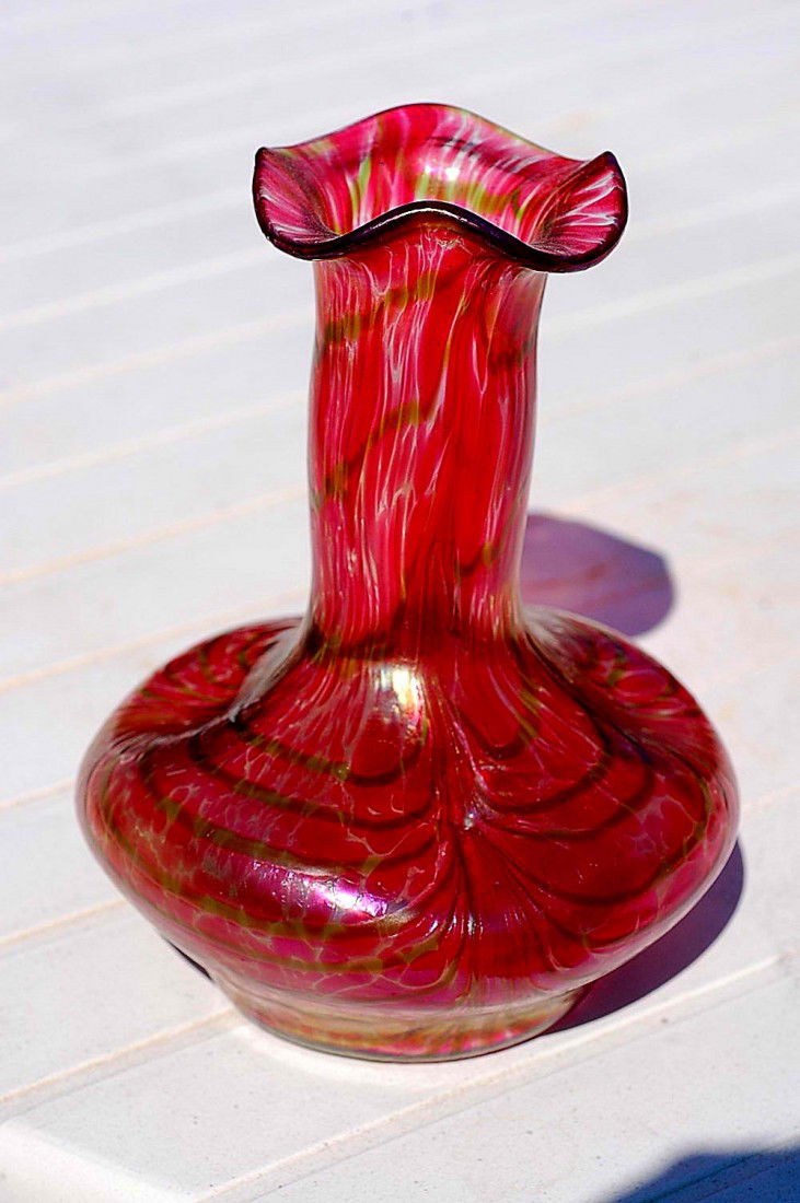 Bohemian attributed to Loetz art glass vase: Bohemian attributed to Loetz art glass vase in an almost never seen red with a dichroic like green pulled waves. The body is oil spot with dimpled accents around the perimeter of the bulbous base. Met