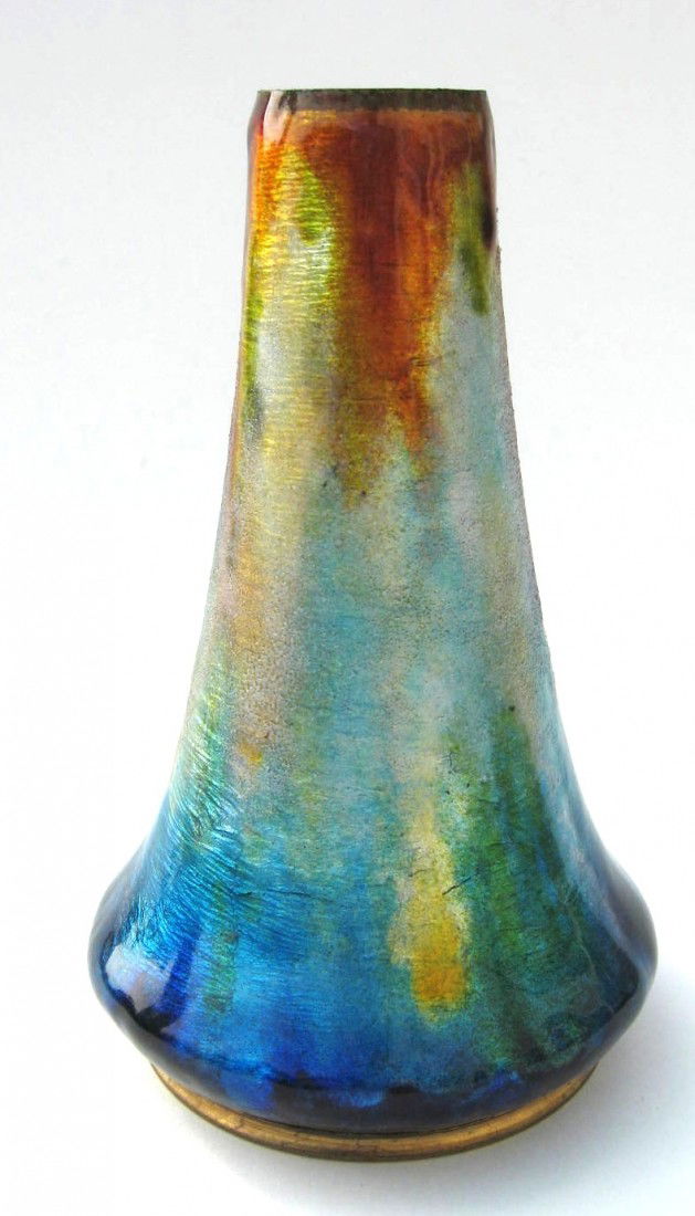Camille Faure Limoges enamel on copper,: trumpet form in mottled iridescent blue red and yellow, signed in the rim Faure Marty Limoges, 6 1/2" ht. Condition: good with a small under glaze u line at the rim, see picture. Estimate: 150-300