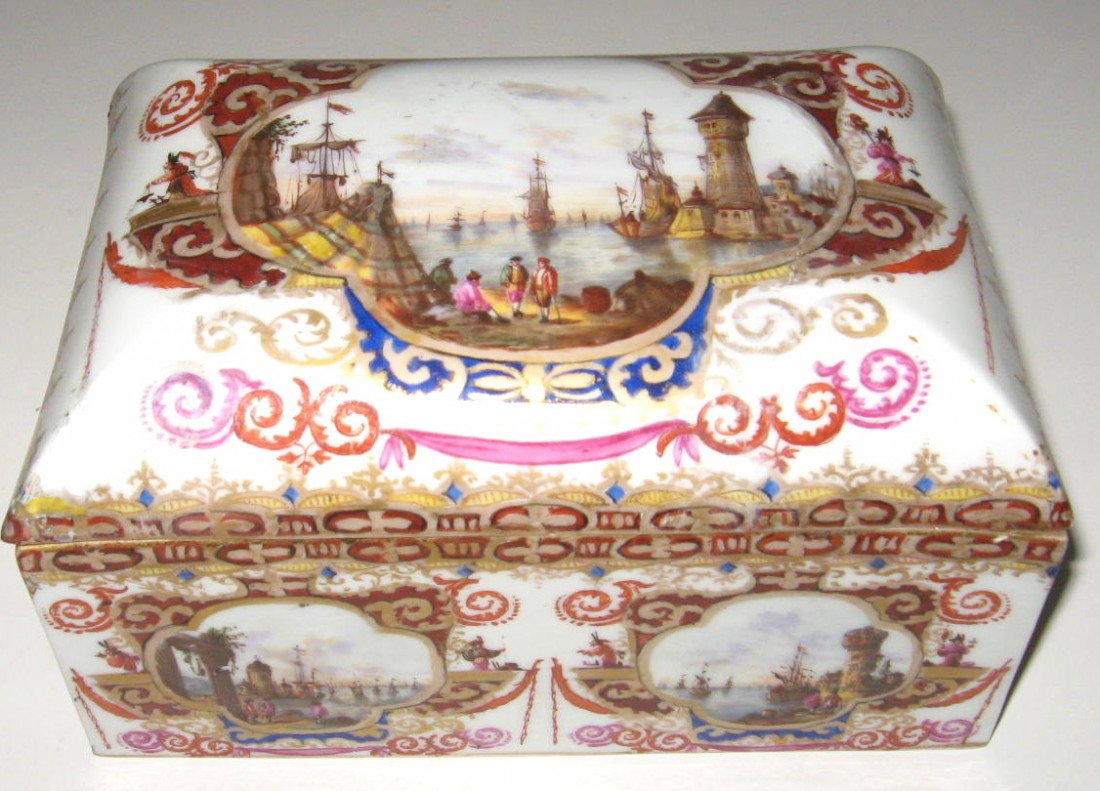 Continental porcelain box, circa 1800,: rectangular form in white porcelain decorated with scrolling medallions of hand painted scenes of European Sea Ports and ships, 7 1/2" long. Condition: good with slight enamel ware,