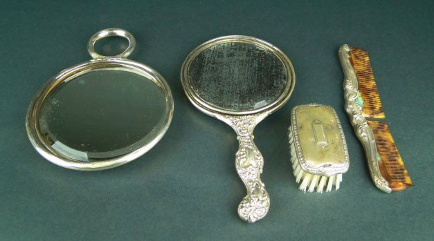 4 ART NOUVEAU STERLING SILVER VANITY ITEMS: 4 ART NOUVEAU STERLING SILVER VANITY ITEMS Sterling Mirror with Putti Measures 9 Inches Long, Second hand Mirror Measures 8 Inches, and a Brush and a Comb which is missing some teeth Very Good Conditi