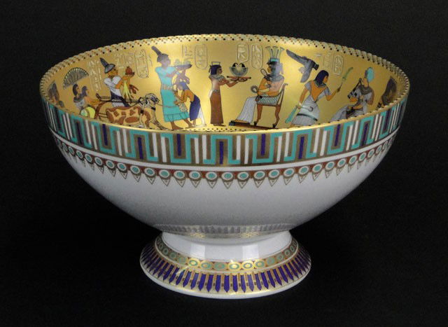20C KAISER PORCELAIN EGYPTIAN BOWL: 20C KAISER PORCELAIN EGYPTIAN BOWL depicting scenes from the life of Tutankhamen. Under glaze Gold Back stamp Kaiser (logo) W. Germany. Very Good Condition. Measures 5-5/8 Inches Tall and 10 Inches Di