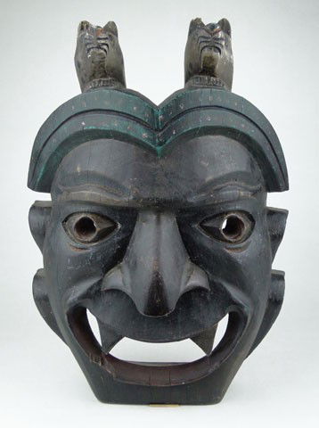 NW COAST INDIAN ANTIQUE MASK: NW COAST INDIAN ANTIQUE MASK Antique Hand Painted Carved Wood with Figural Wolf Horns Measures Approximately 15 Inches Long 12 Inches Wide One inch Loss to Mouth and Age Cracks otherwise very good con