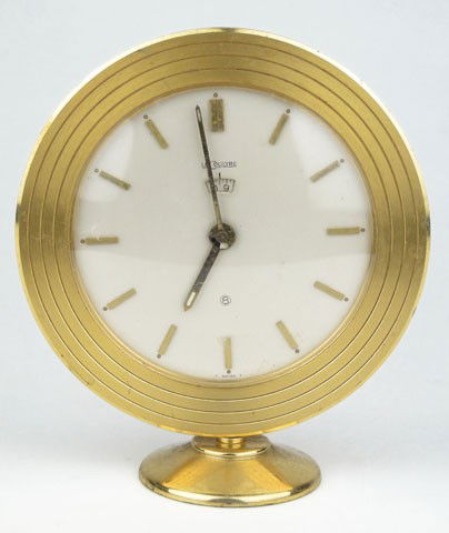 LE COULTRE BRONZE 8 DAY CLOCK: LE COULTRE BRONZE 8 DAY CLOCK Clock Measures Approximately 4 Inches in Diameter 4-3/4 Inches Tall Needs Servicing otherwise Very Good Condition, SHIPPING $30 PLUS INS