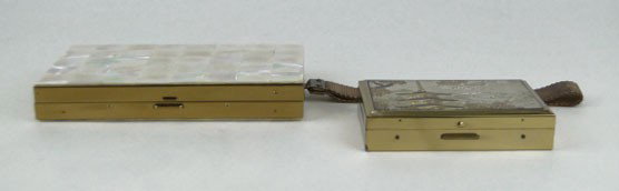 TWO (2) VINTAGE LADIES COMPACTS W BOXES: TWO (2) VINTAGE LADIES COMPACTS W BOXES Consisting of a Mother of Pearl 5 Inch Compact and a Clover Chinese Musical 4 Inch Compact, SHIPPING $25 PLUS INS