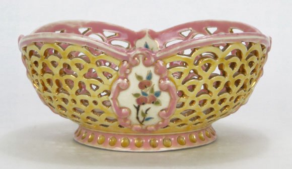 ANTIQUE ZSOLNAY PORCELAIN RETICULATED BOWL: ANTIQUE ZSOLNAY PORCELAIN RETICULATED BOWL with hand Painted Fruit & floral Design Pink Interior Typical Light Crazing With the Zsolnay Pecs Blue Under Glaze mark Measures Approximately 8-1/2 Inches D