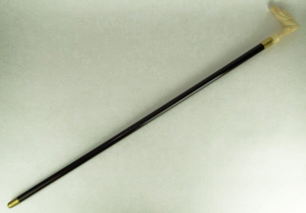VINTAGE EROTIC IVORY HANDLE WALKING STICK: VINTAGE EROTIC IVORY HANDLE WALKING STICK Handle Depicts an Erotic Study Carved out of Walrus Tusk. Wood Shaft with Brass Tip. Stick Measures Approximately Overall 37-1/2 Inches Tall Very Good to Exce