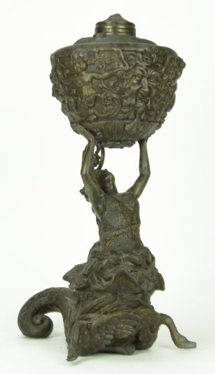 EXTRODINARY ANTIQUE FIGURAL OIL LAMP: EXTRODINARY ANTIQUE FIGURAL OIL LAMP Woman with Snail Skull Cap Rising out of Serpent Cornacopia Body with Scales on Her Torso. Front Feet Swans Honking Holding a Container with Putti & Evil Faces Dat