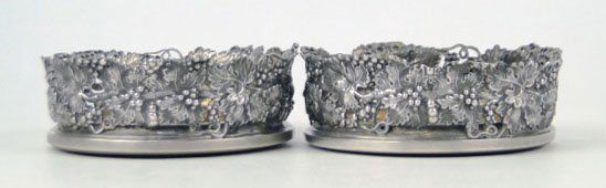 PAIR ANTIQUE CONTINENTAL 800 STERLING SILVER COAST: PAIR ANTIQUE CONTINENTAL 800 STERLING SILVER COASTERS to Hold Champagne Bottles. Each Has Wood Bases with Ornate Repousse Leaf & Grape Design Measures Approximately 4-1/2 Inches in Diameter Weight wit