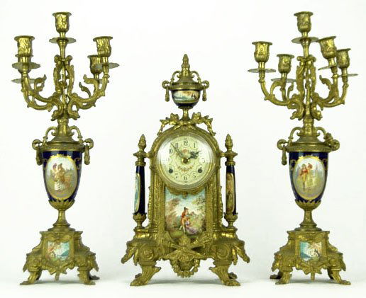 ANTIQUE CONTINENTAL THREE PIECE GARNITURE SET: ANTIQUE CONTINENTAL THREE PIECE GARNITURE SET Bronze Candelabras with Hand Painted Sieves Style Porcelain Inserts Each Measures Approximately 19 1/4 Inches Tall Along with Matching Clock with German M