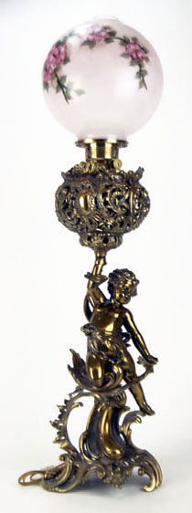 LARGE ANTIQUE GONE WITH THE WIND LAMP: LARGE ANTIQUE GONE WITH THE WIND LAMP Measures Approximately 36 Inches Tall. Consisting of a Brass Based Putti on Ornate Base Holding up a Hand Painted Pink Floral Globe with Chimney. In Working Condi