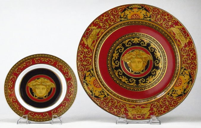 TWO VERSACE ROSENTHAL CHARGERS: TWO VERSACE ROSENTHAL CHARGERS Black Versace Embalm on Bottom. With the Versace Woman in Persimmon Ground. The Largest Measures Approximately 12" in Diameter. WE WILL NOT SHIP THIS ITEM BUT CAN RECOMM