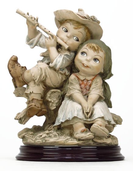 GIUSEPPE ARMANI FIGURINE TITLED "SERENADE": GIUSEPPE ARMANI FIGURINE TITLED "SERENADE" #0660-T. Limited Edition, 777/1000. Measures Approximately 8-1/2" Tall on a 1" Base. Depicting a Boy and Girl Sitting Together, the Little Boy is Playing a F