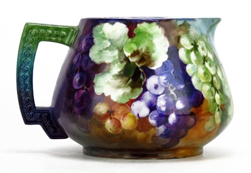 ANTIQUE LIMOGES CIDER PITCHER: ANTIQUE LIMOGES CIDER PITCHER Jean Puoyett with Hand Painted Grapes and Floral Design on a Lavender Ground. Measures Approximately 6-1/2" Tall by 8-1/2" Wide. WE WILL NOT SHIP THIS ITEM BUT CAN RECOMM