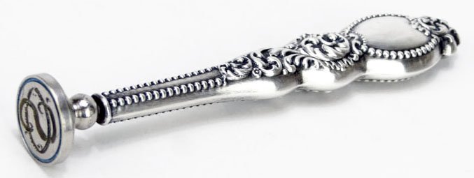 ANTIQUE STERLING SILVER HANDLED STAMP: ANTIQUE STERLING SILVER HANDLED STAMP with Ornate Sterling Handle. Measures Approximately 4-1/2" Long. WE WILL SHIP THIS ITEM FOR $20 PLUS INSURANCE