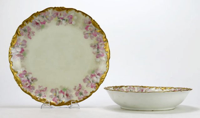 ANTIQUE HAND PAINTED LIMOGES FRUIT BOWL AND UNDER PLATE: ANTIQUE HAND PAINTED LIMOGES FRUIT BOWL AND UNDER PLATE Tressman & Voiogt co, beautiful flora design, with gold trim measures 10" in diameter, very good condition, marked to base, circa 1915