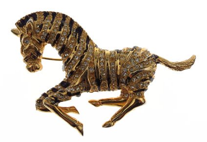 A VINTAGE HATTIE CARNEGIE ZEBRA BROOCH: A VINTAGE HATTIE CARNEGIE ZEBRA BROOCH approx 2"This is an early Hattie Carnegie Zebra pin made of gold tone metal and embellished with black enameled and white rhinestone stripes.It measures 2" X 1 1