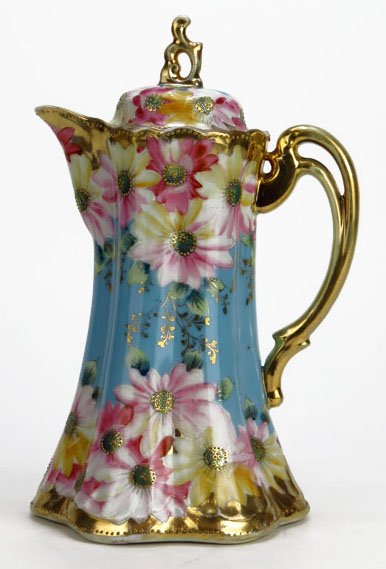 BEAUTIFUL HAND PAINTED NIPPON CHOCOLATE POT: BEAUTIFUL HAND PAINTED NIPPON CHOCOLATE POT. Measures 10" tall with lid. Unsigned beautiful raised flowers in pink and yellow on a robins egg blue ground. We will not ship this item. We will happily r