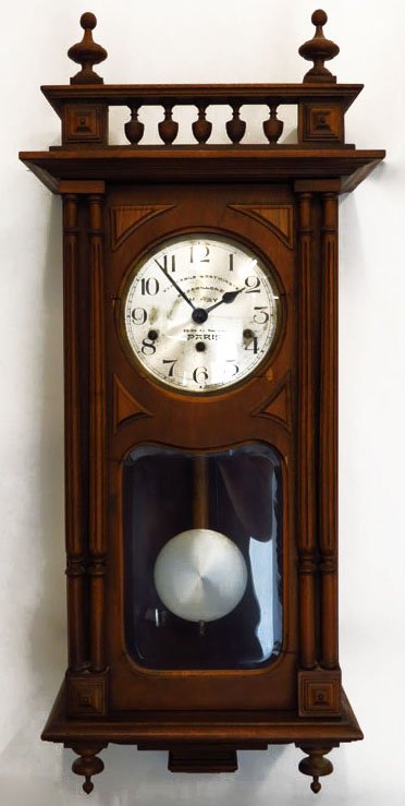 ANTIQUE CLOCK WITH WESTMINSTER CHIME: ANTIQUE CLOCK WITH WESTMINSTER CHIME. Large regulator clock measures 31" tall 15" wide. Case opens up to a copper face signed Paris, has original pendulum. And hand carved finials. Appears to be in wo