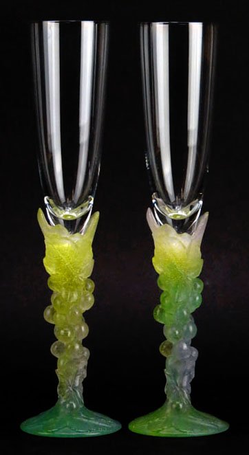 PAIR OF RARE DAUM PATE DE VERRE CHAMPAGNE FLUTES: Each measures 10.5" tall with grape stems in a multin green hue in excellent condition signed to base. We will not ship this lot but we can recommend one of our local shippers.