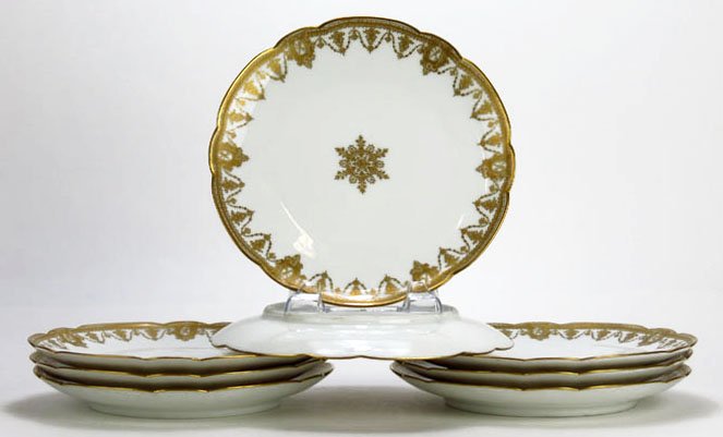 8 ANTIQUE LIMOGES GOLD RIM SCALLOP PLATES: 8 ANTIQUE LIMOGES GOLD RIM SCALLOP PLATES each measures 8.5" diameter from Havalin and Co. with a gold snow flake on ivory grounds We will not ship this lot but we can recommend one of our local shipp