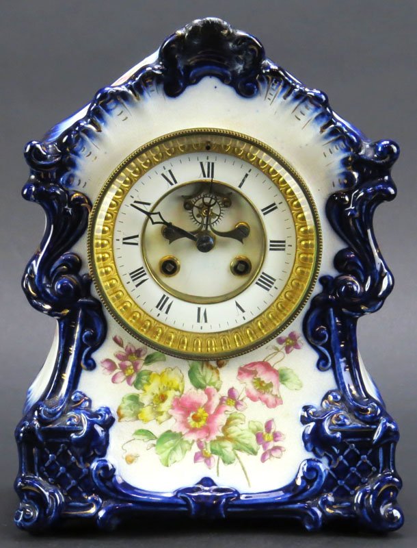 Royal Bonn Style Ceramic Clock. No Pendulum, No Key.: Royal Bonn Style Ceramic Clock. No Pendulum, No Key. Restoration to Finial or else Good Condition. Please Examine This Item Carefully Before Bidding. Measures 11 Inches Tall and 7-3/4 Inches Wide. Shi
