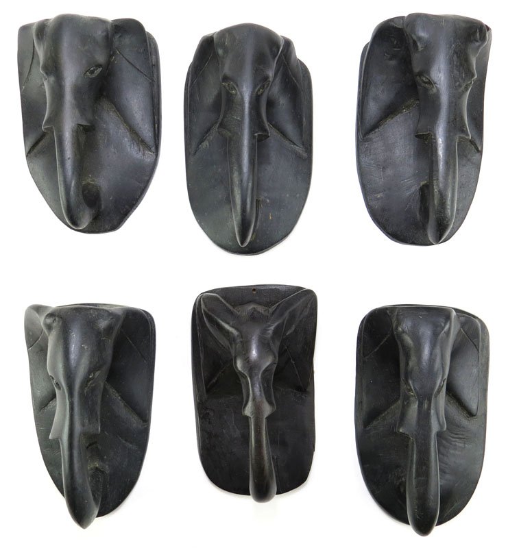 Six (6) African Carved Wooden Elephant Head Wall: Six (6) African Carved Wooden Elephant Head Wall Hangings or Door Pulls. Good Condition. Measures 6-3/4 Inches Tall and 4 Inches Wide. Shipping $40.00