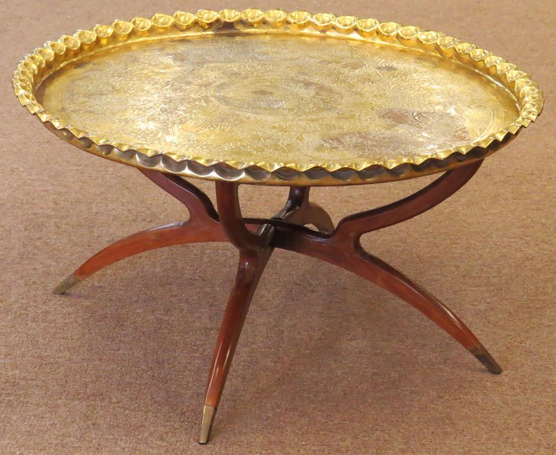 Mid Century Persian Brass Tray Table with Wooden Base.: Mid Century Persian Brass Tray Table with Wooden Base. Unsigned. Good Condition. Measures 20 Inches Tall and 36-1/2 Inches Diameter. We Will Not Ship This Item In-House Due to Its Size, But Would be H