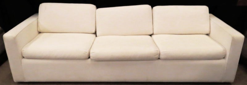 Art Deco Style White Upholstered Couch. Unsigned. Light: Art Deco Style White Upholstered Couch. Unsigned. Light Staining or else Good Condition. 24-1/2 Inches by 98 Inches. We Will Not Ship This Item In-House Due to Its Size, But Would be Happy to Recommen