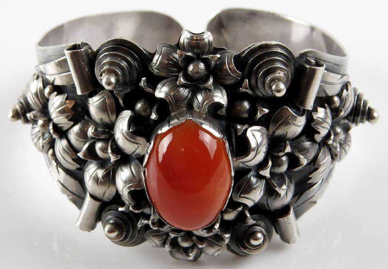 Intricate Sterling Silver Bangle Bracelet with: Intricate Sterling Silver Bangle Bracelet with Carnelian Insert. Unsigned. Very Good Condition. Weighs 1.66 Troy Ounces. Shipping $20.00