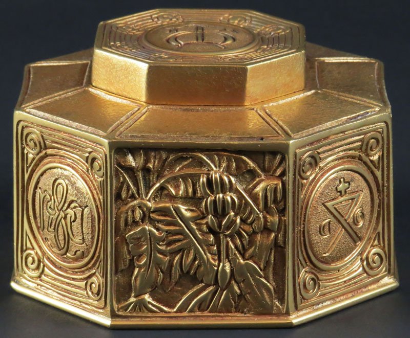 Mid Century Tiffany Studios Bronze Octagonal Ink Well: Mid Century Tiffany Studios Bronze Octagonal Ink Well with Each Side Depicting a Different Nautical Symbol and Plants. Signed. Glass Insert is Chipped on Rim, Has Blemishes around Bottom Edge, Otherwi