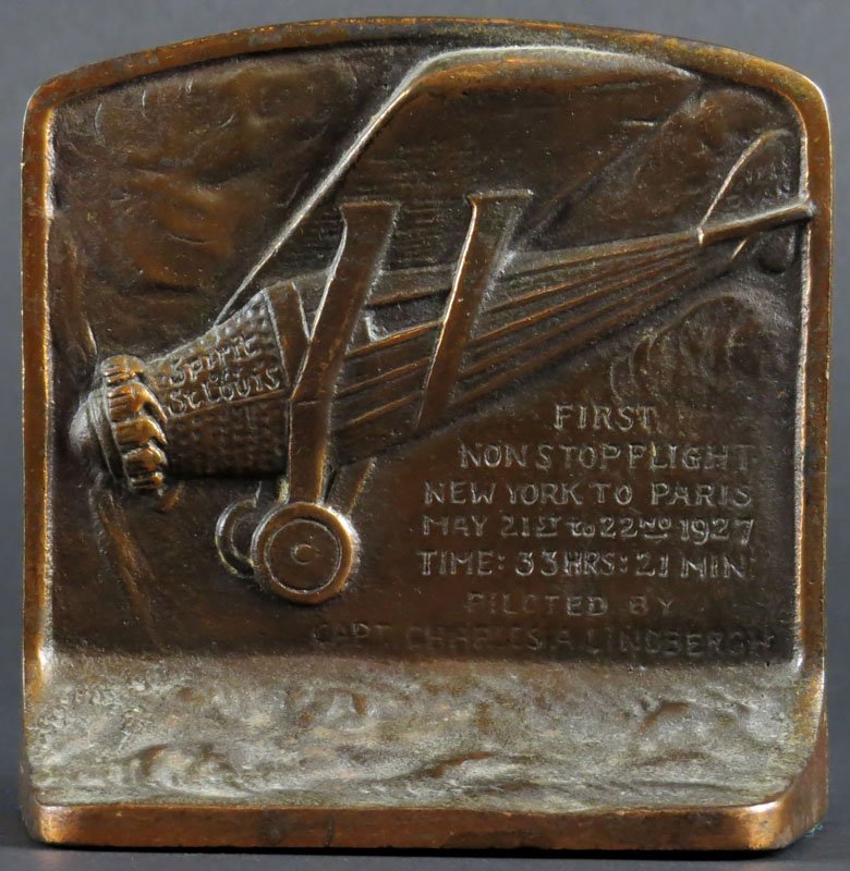 First Flight New York to Paris Charles Lindberg Single: First Flight New York to Paris Charles Lindberg Single Iron Bookend. Signed. Good Condition. Measures 4-1/2 Inches and 5 Inches Wide. Shipping $20.00