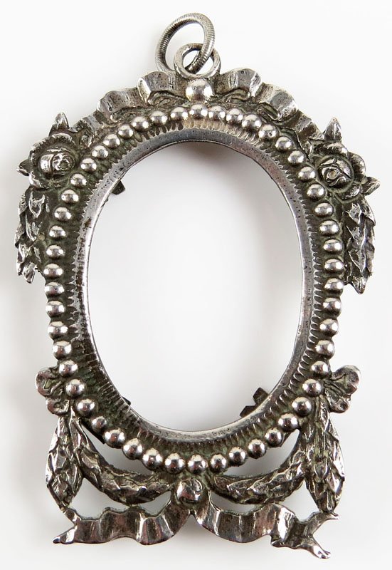Unusual Sterling Silver Frame with a Keychain or: Unusual Sterling Silver Frame with a Keychain or Chatelaine Hook. Unsigned. One (1) Rear Holding Clip Missing or else Good Condition. Weighs 0.37 Troy Ounces. Measures 2-5/8 Inches by 2 Inches. Shippi