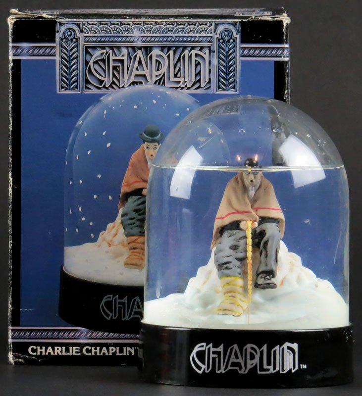 Enesco Snowglobe Charlie Chaplin Waterdome in Original: Enesco Snowglobe Charlie Chaplin Waterdome in Original Box. Very Good Condition. Measures 4-3/8 Inches Tall. Shipping $20.00