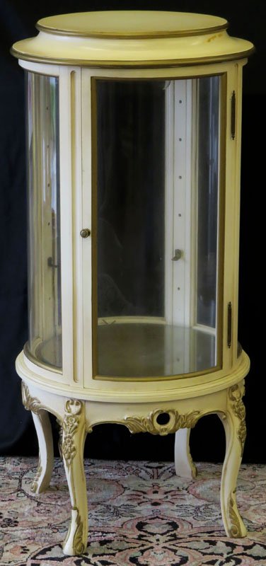 Mid Century French Provincial White Display Cabinet: Mid Century French Provincial White Display Cabinet with Glass Front and Sides. Unsigned. Minor Scratching and Staining or else Good Condition. Measures 39 Inches Tall and 18 Inches Diameter. We Will 