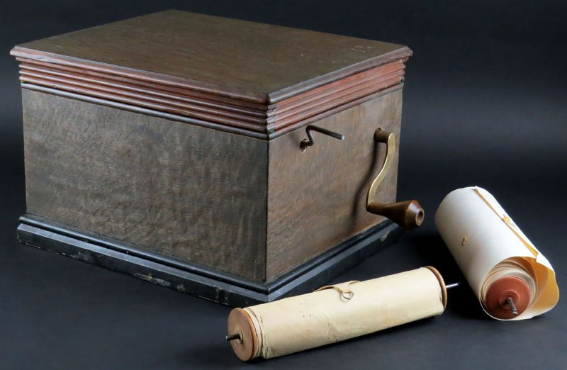 Antique Roller Organ Music Box Casket with Two (2): Antique Roller Organ Music Box Casket with Two (2) Extra Rolls. Good Condition and Works. Has Playing Handle and Rewind Key. Has Limited Paperwork. Measures 8-1/2 Inches by 13 Inches. Shipping $70.00