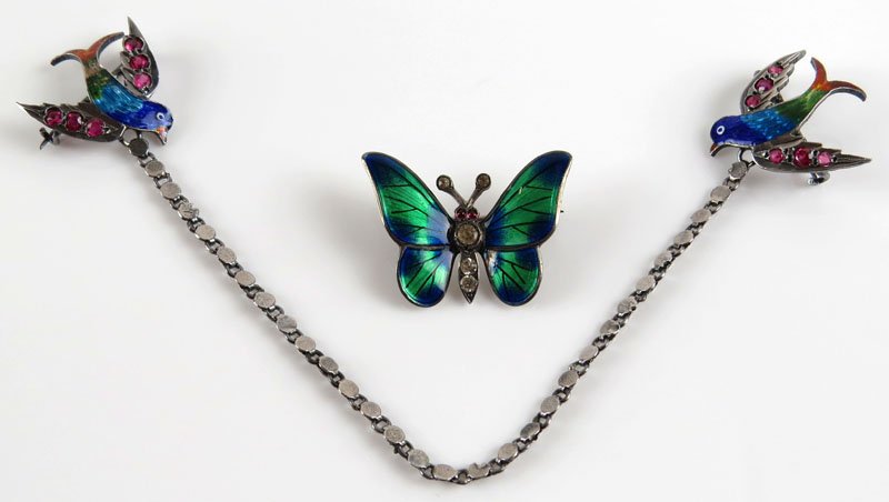 Mid Century Sterling Silver and Enamel Sweater Pin with: Mid Century Sterling Silver and Enamel Sweater Pin with Faux Stones together with Sterling Silver, Enamel and Faux Stone Butterfly. Sweater Pin Unsigned, Butterfly Signed 935. Good Condition. Weighs 6