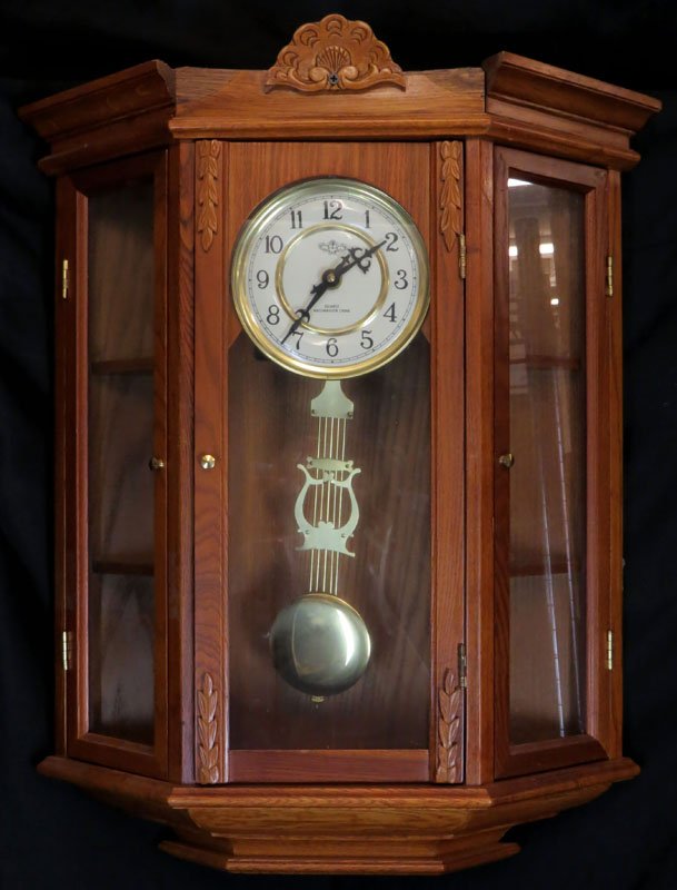 Large Modern D & A Wooden Wall Clock Display Case with: Large Modern D & A Wooden Wall Clock Display Case with Westminster Chimes. Signed. Losses to Top Center Area and Repair to Finial or else Good Condition but has a few scuffs, nicks etc. Measures 19 In