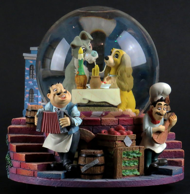 Large Disney Lady and the Tramp Snow Globe. Plays Bella: Large Disney Lady and the Tramp Snow Globe. Plays Bella Notte. Signed. Good Condition. Running Condition. Measures 7 Inches Tall and 6-1/2 Inches Diameter. Shipping $20.00