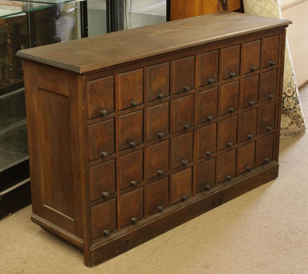Large Antique Oak Wooden Thirty-Two (32) Bottle Wine: Large Antique Oak Wooden Thirty-Two (32) Bottle Wine Cabinet. Some Damage to sliding Door, Scratches, and wear or else Good Condition. Measures 33 Inches High by 53 Inches Wide. We Will Not Ship This 
