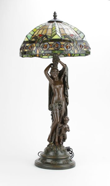 Design Toscano Nude with Cherub Composition Lamp with: Design Toscano Nude with Cherub Composition Lamp with Stained Glass Shade. Hardware for Shade Slightly Bent. Measures 28" H by 12" at the Widest Point. We Will Not Ship This Item Due to Its Size but w