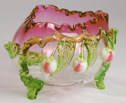 Stevens & Williams Tri-Cornered Bowl: Stevens & Williams tri-cornered, crimped edge cranberry to clear bowl with green applied leaves and feet, white and red cherries. Polished pontil. 5"h x 7"w.